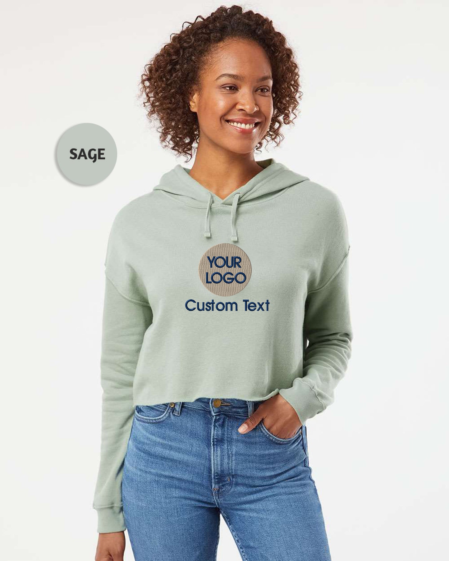 a woman wearing a light green hoodie with your logo on it