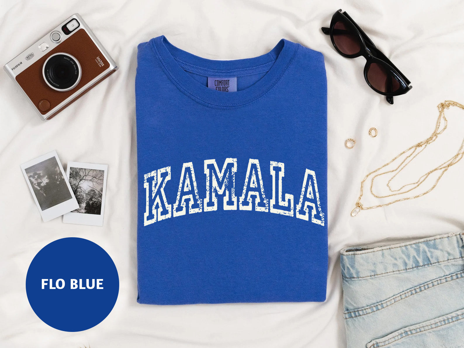 a blue shirt with the word kalamala on it next to a pair of