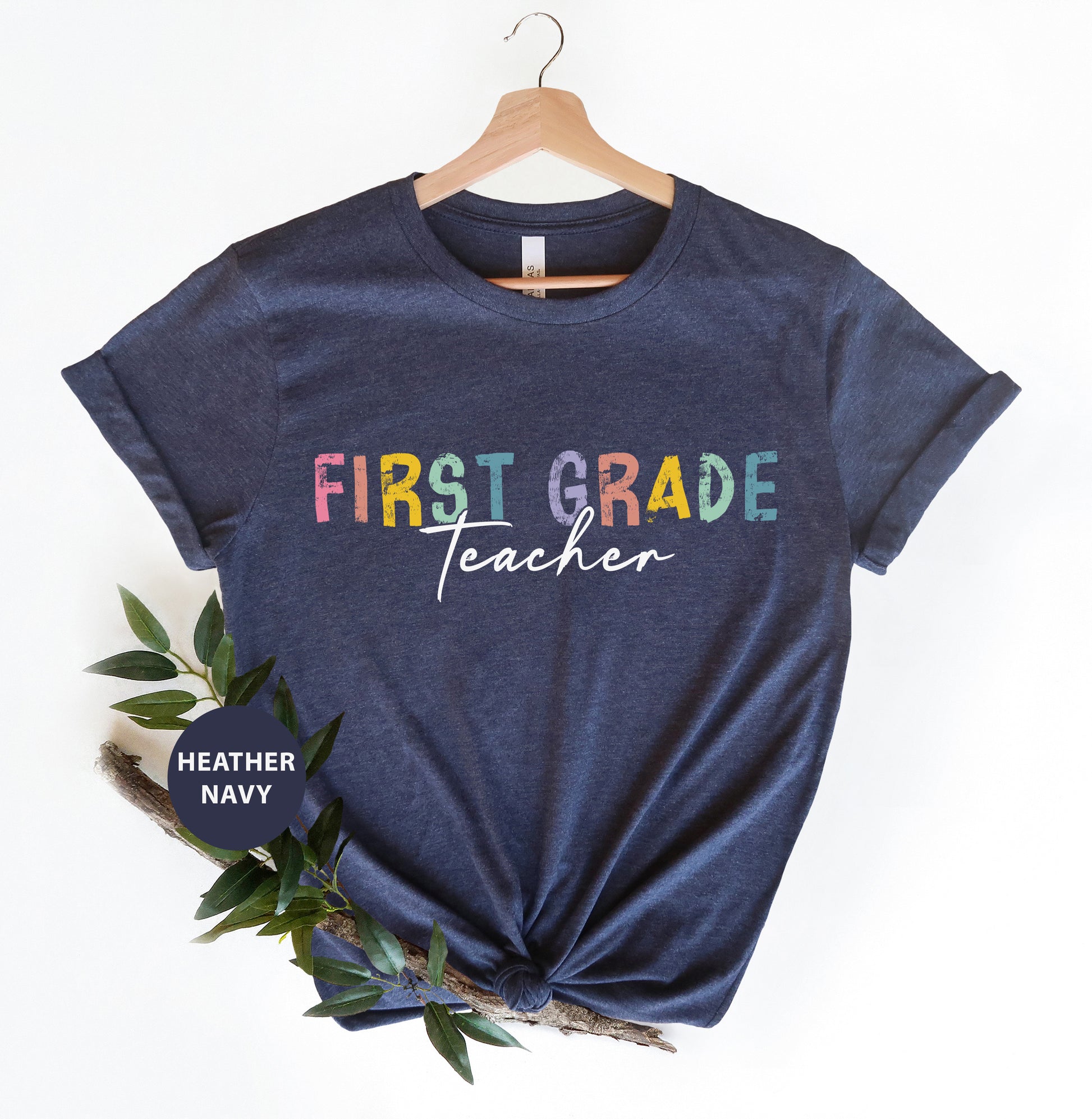 a t - shirt with the words first grade teacher on it