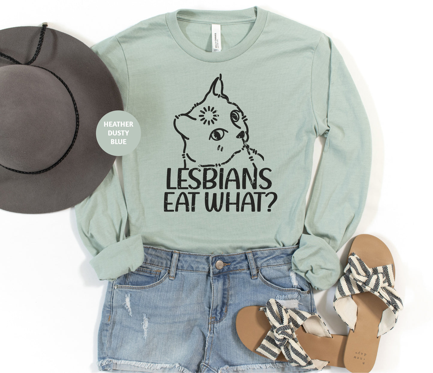 a shirt that says lesbians eat what? next to a hat and sandals