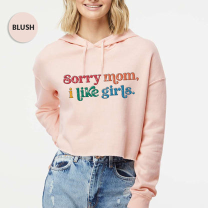 a woman wearing a pink hoodie that says sorry mom i like girls