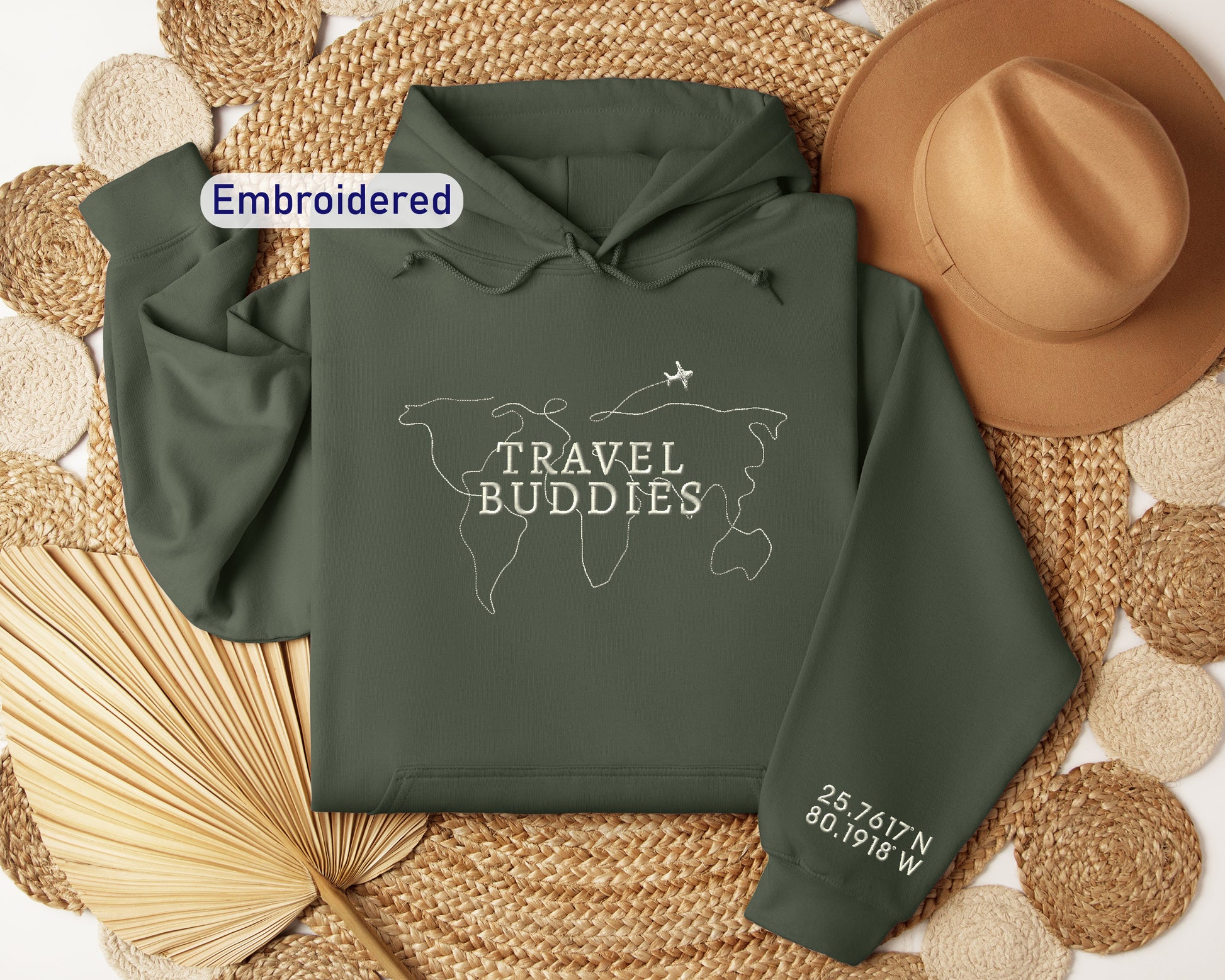 a green hoodie with the words travel buddies printed on it