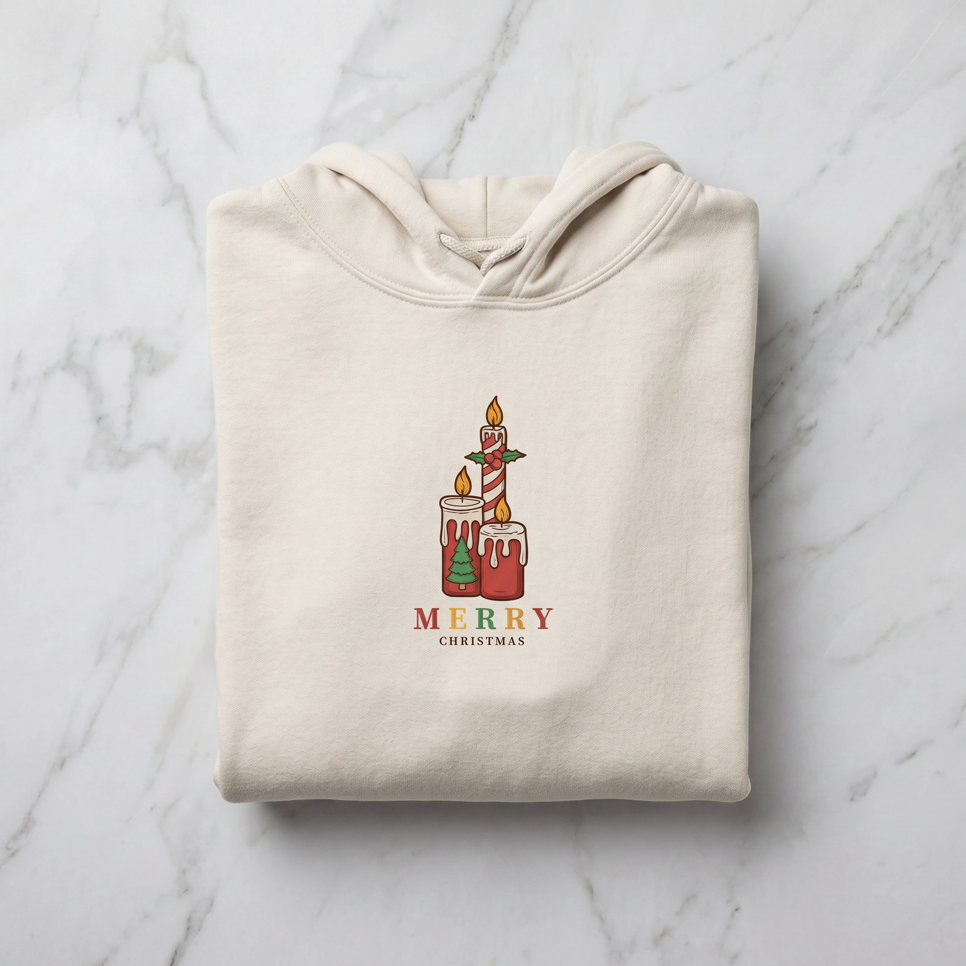 A beige hoodie with a graphic design of two lit candles and the text "MERRY CHRISTMAS" printed on it.