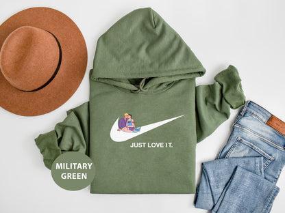 a green hoodie, hat, jeans and a pair of shoes