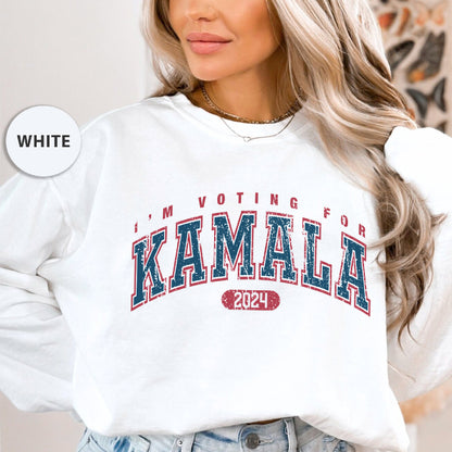 a woman wearing a white sweatshirt that says i'm voting for kaamala