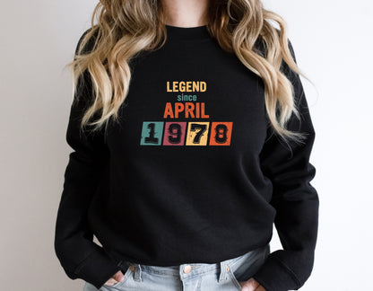 A person wearing a black sweatshirt with the text "LEGEND SINCE APRIL 1978" printed on it.