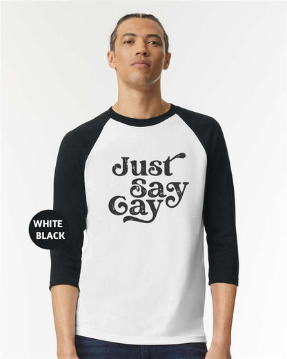 a man wearing a black and white shirt with the words just gay printed on it