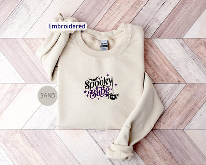 a white sweatshirt with the words spooky sauce on it