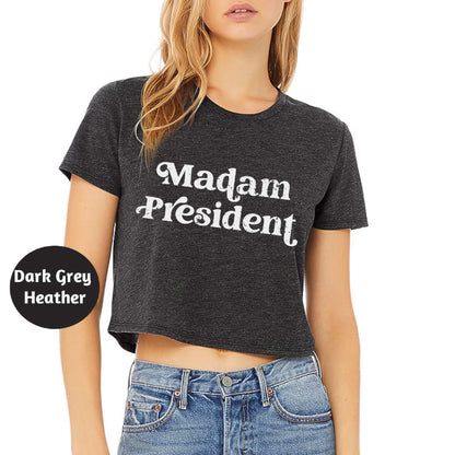 a woman wearing a crop top that says madam president