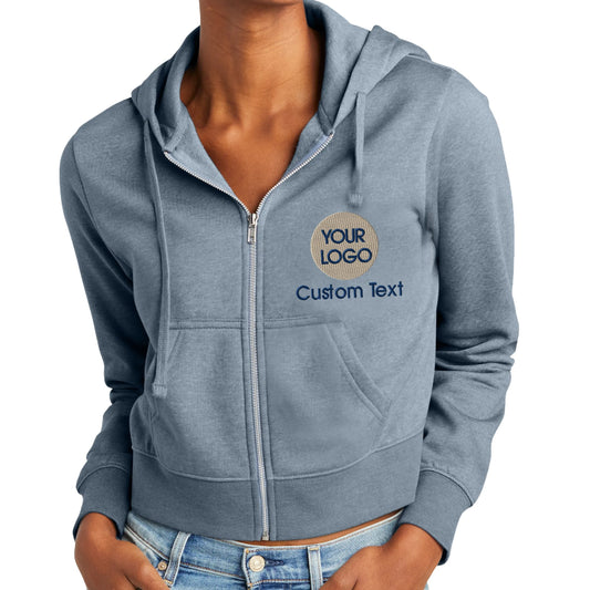 a woman wearing a blue zip up hoodie