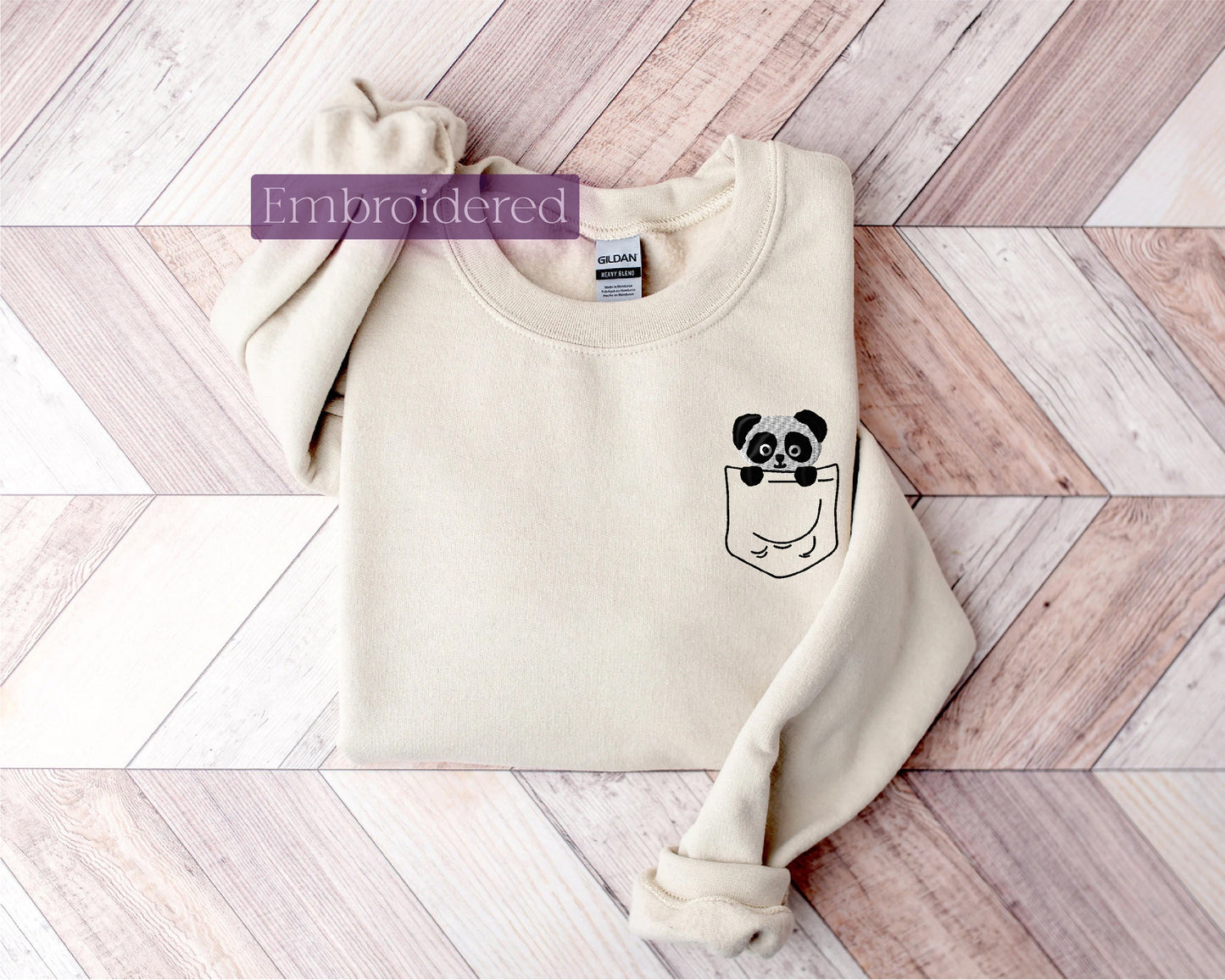 a white sweater with a panda face on it