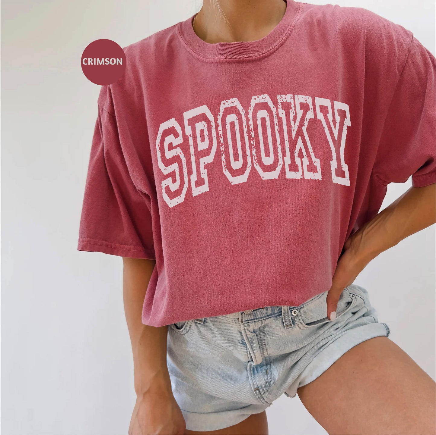 a woman wearing a red shirt with the word spooky on it