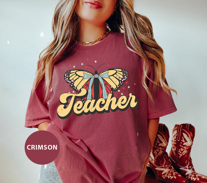 a girl wearing a t - shirt with a butterfly on it