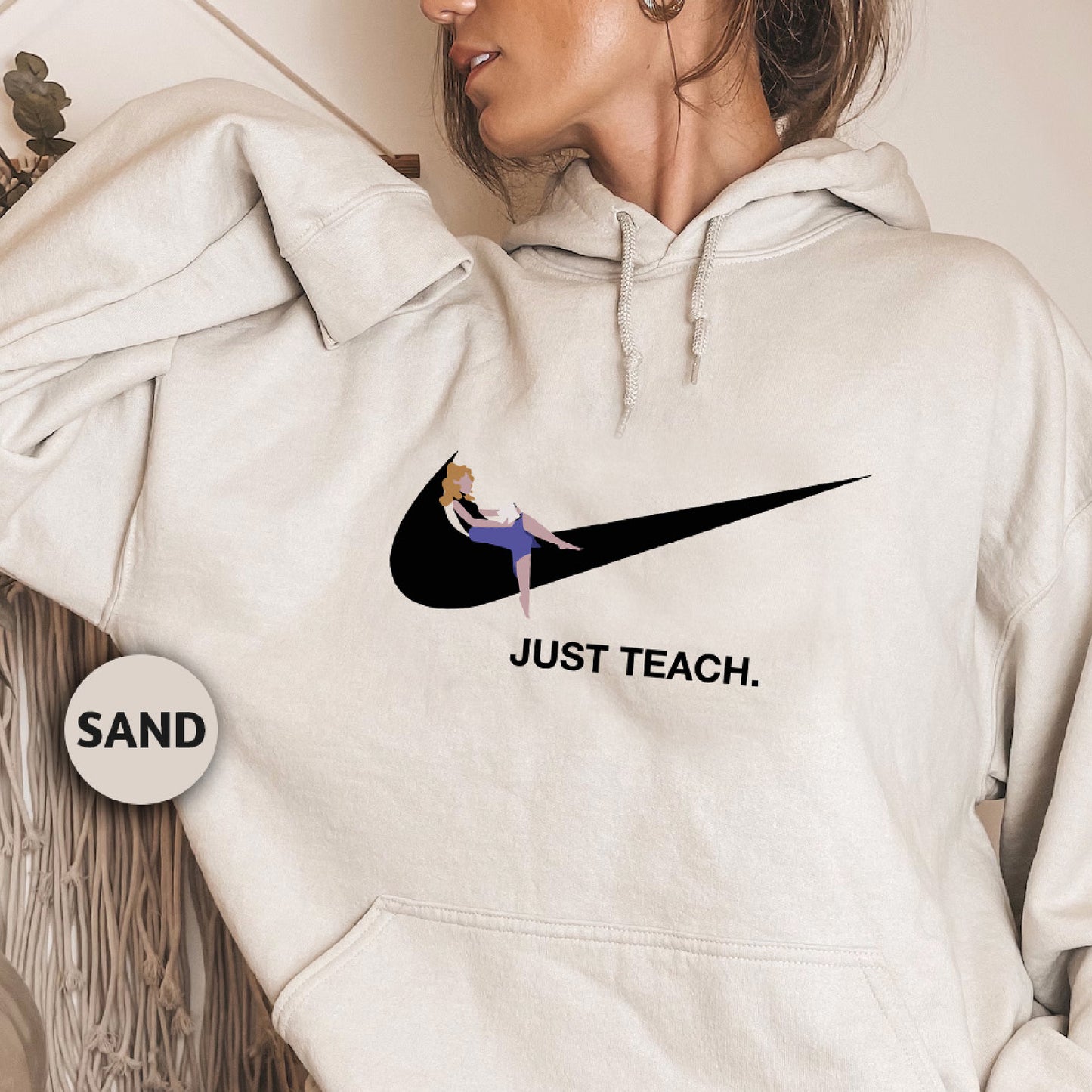 a woman wearing a white nike hoodie with the slogan just teach