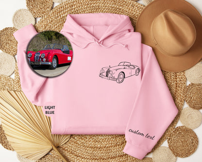 a pink hoodie with a picture of a car on it