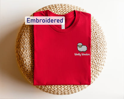 a red shirt with a sheep embroidered on it