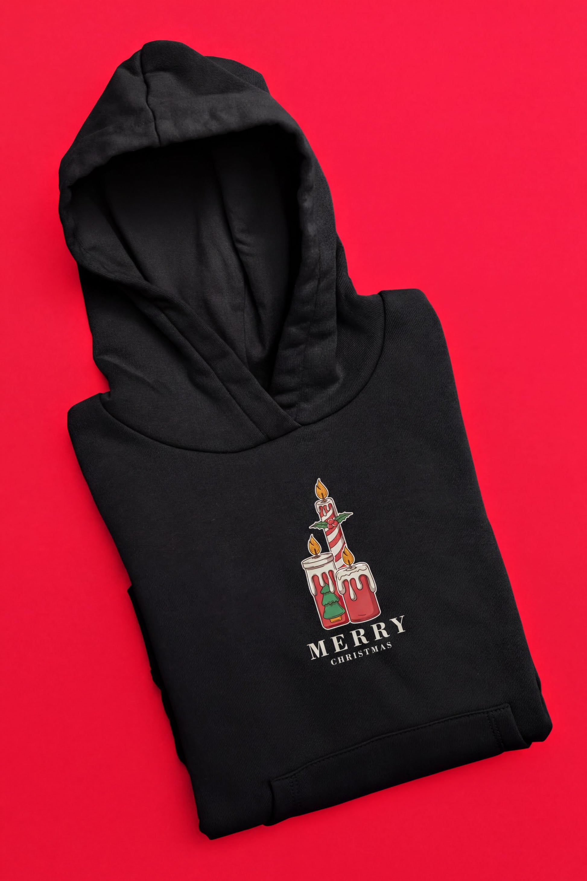 A black hoodie with a graphic design on the front, including a candle and the text "MERRY CHRISTMAS".