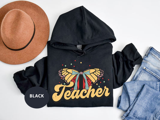 a black hoodie with a yellow butterfly on it
