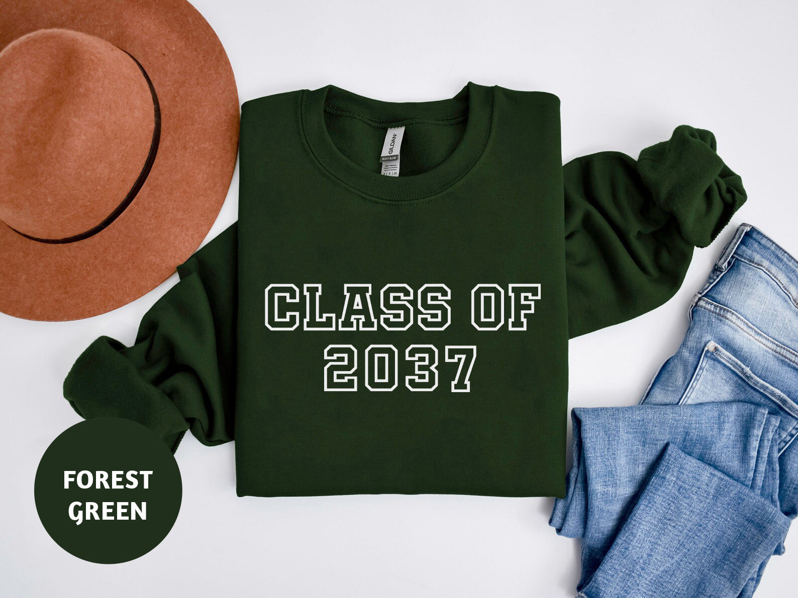 a green shirt that says class of 2017 next to a hat and jeans