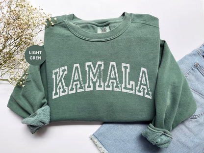 a green sweatshirt with the word kalamala printed on it