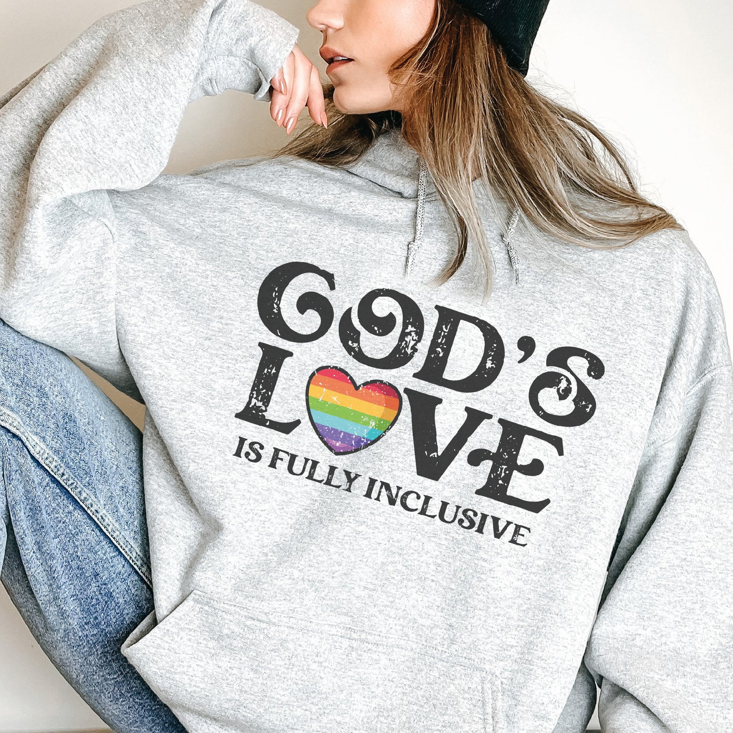 a woman wearing a hoodie that says god's love is fully inclusive