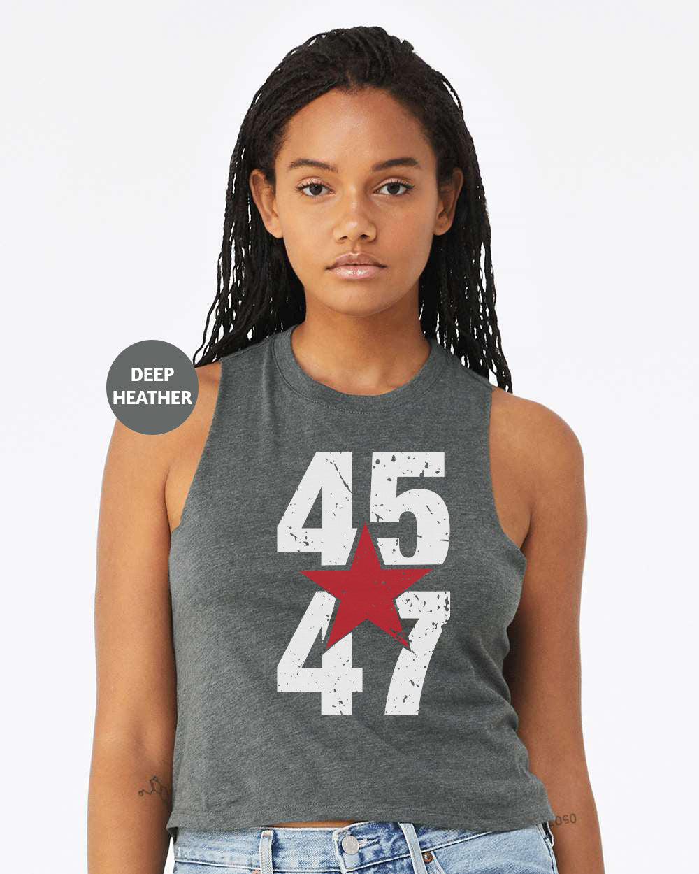 a woman wearing a tank top with the number 477 on it