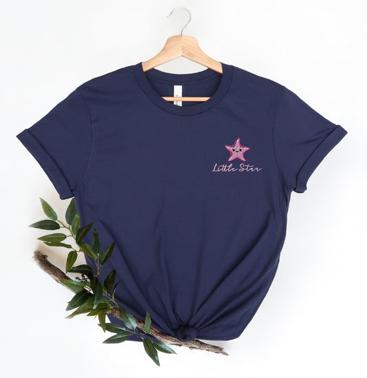 a t - shirt with a pink star on it