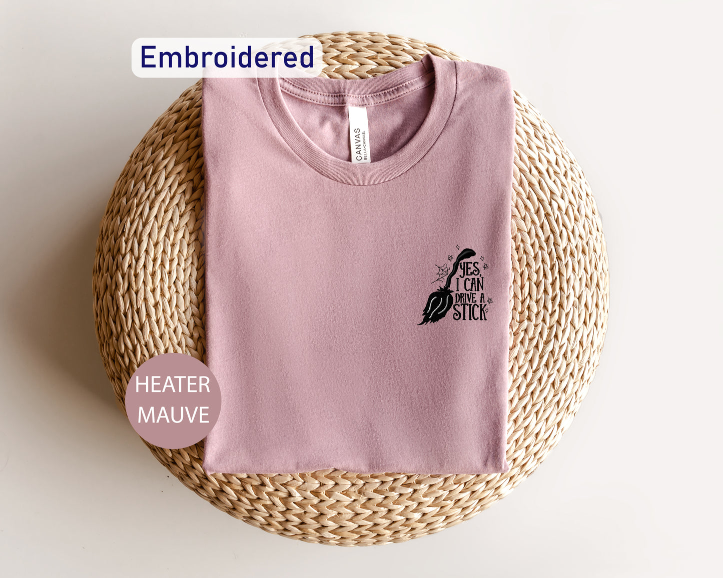 a pink t - shirt sitting on top of a wicker basket