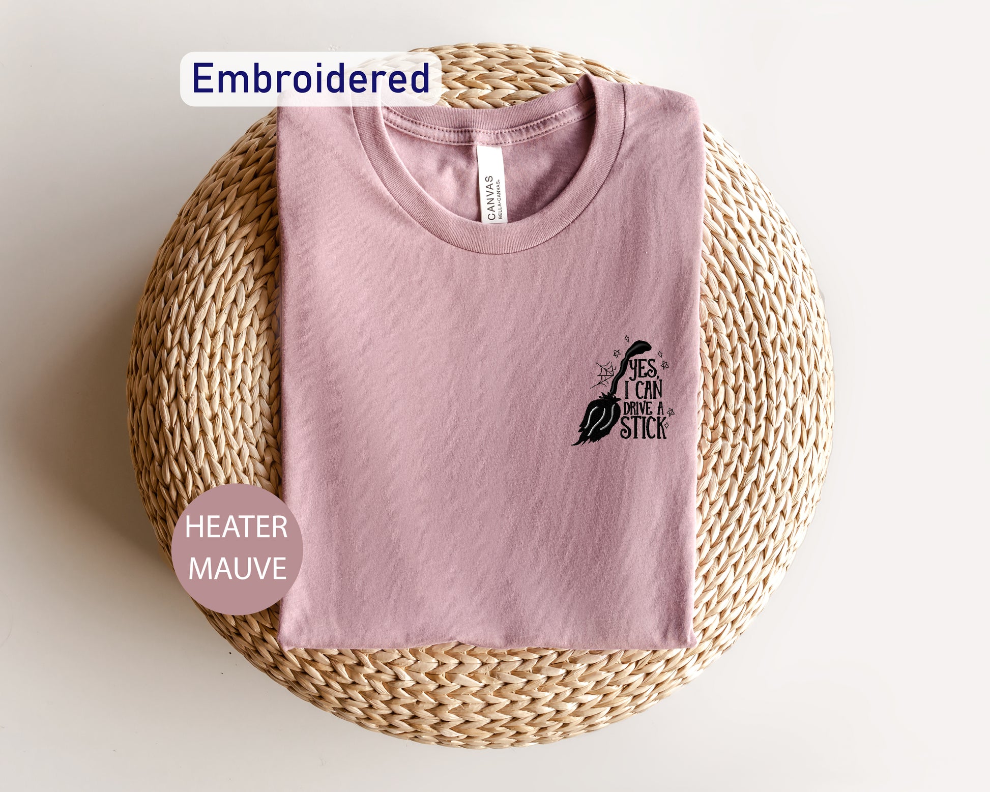 a pink t - shirt sitting on top of a wicker basket