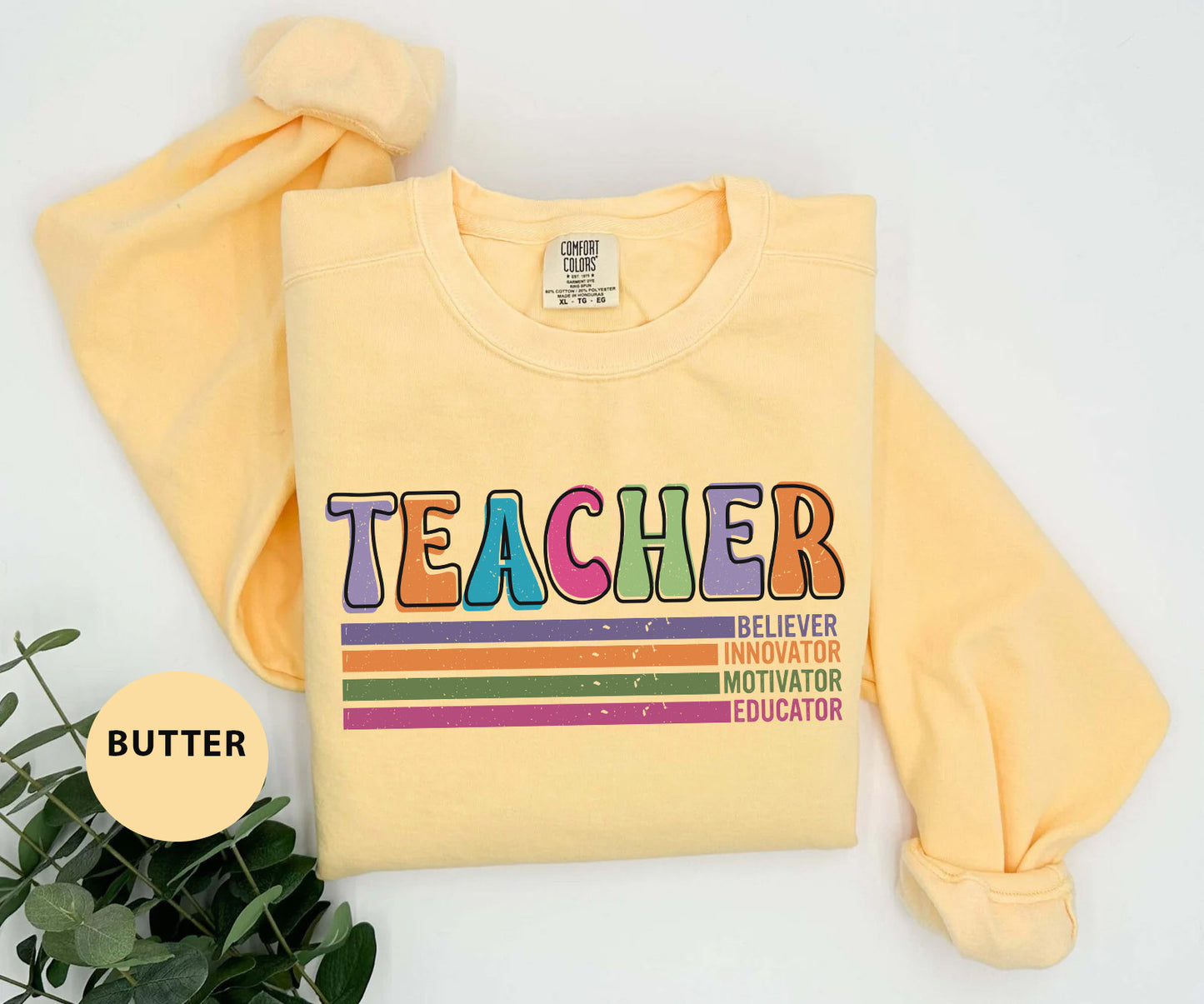 a yellow shirt with the words teacher on it