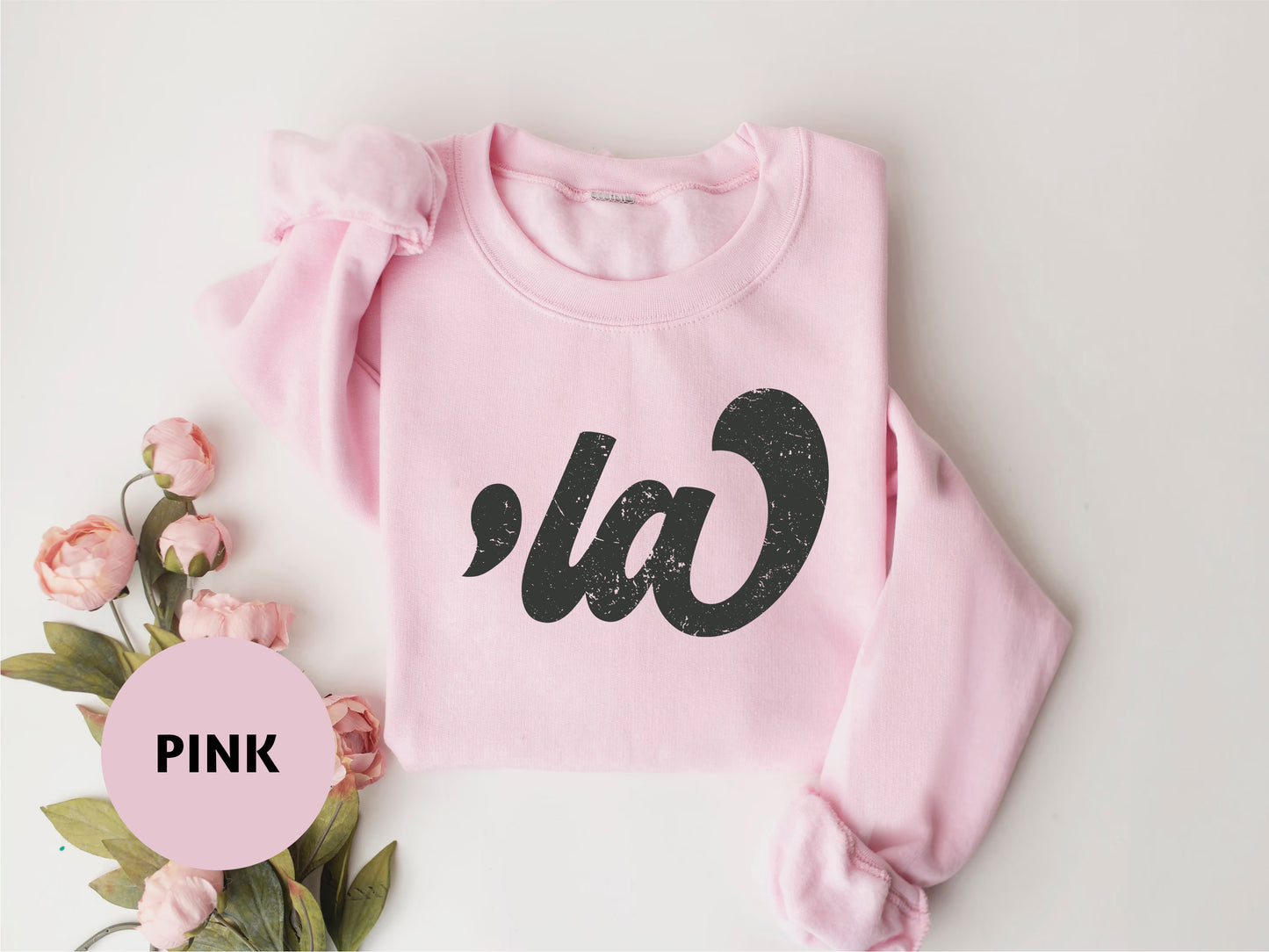 a pink sweater with the word pink on it