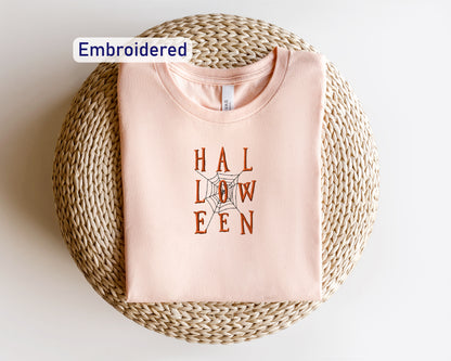 a pink t - shirt with the words hall low en printed on it