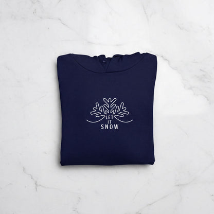 A navy blue hoodie with a white snowflake design and the text "LET IT SNOW" printed on it.