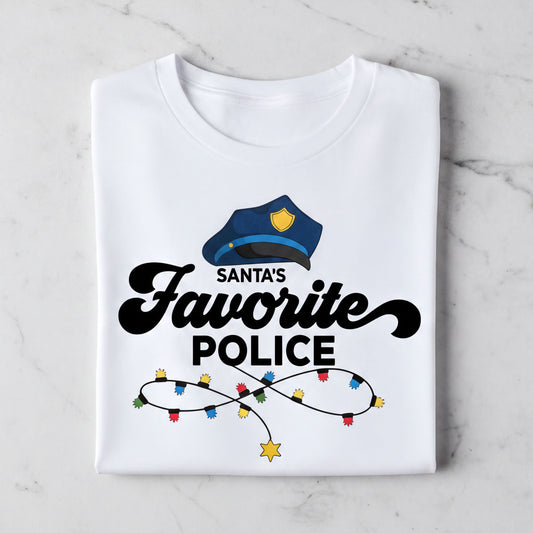 A white t-shirt with a graphic design featuring a police officer's hat and the text "Santa's Favorite Police" along with colorful lights.