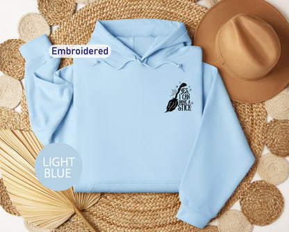 a light blue hoodie with an embroidered bird on it