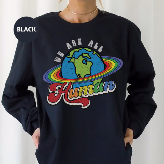 a woman wearing a black sweatshirt that says we are all human