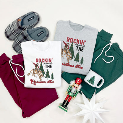 various Christmas-themed items, including two t-shirts, a pair of slippers, a nutcracker, a mug, and a star, all arranged on a white background.