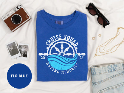 a blue tshirt with a picture of a boat and a pair of sunglasses