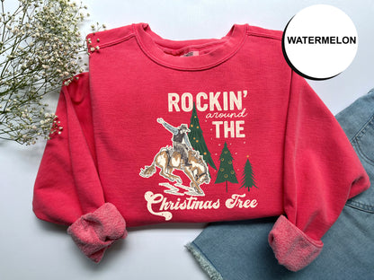 A red sweater with a graphic design and text printed on it, along with some flowers and a denim skirt.
