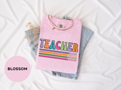 a pink shirt that says teacher on it