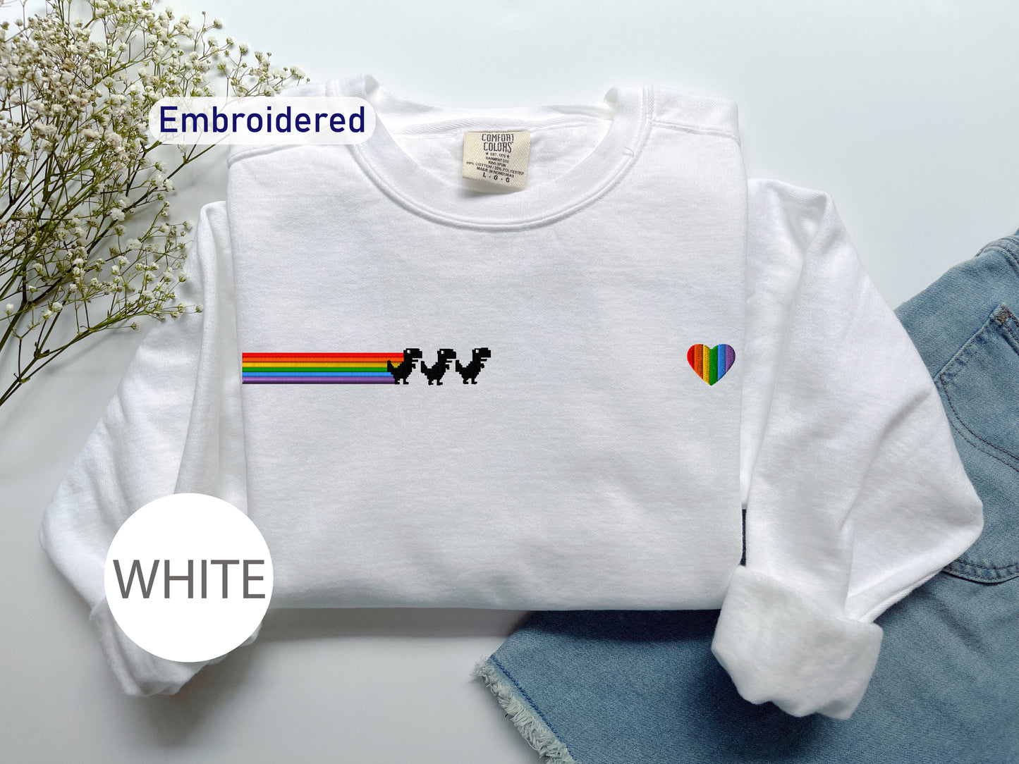 a white shirt with a rainbow on it