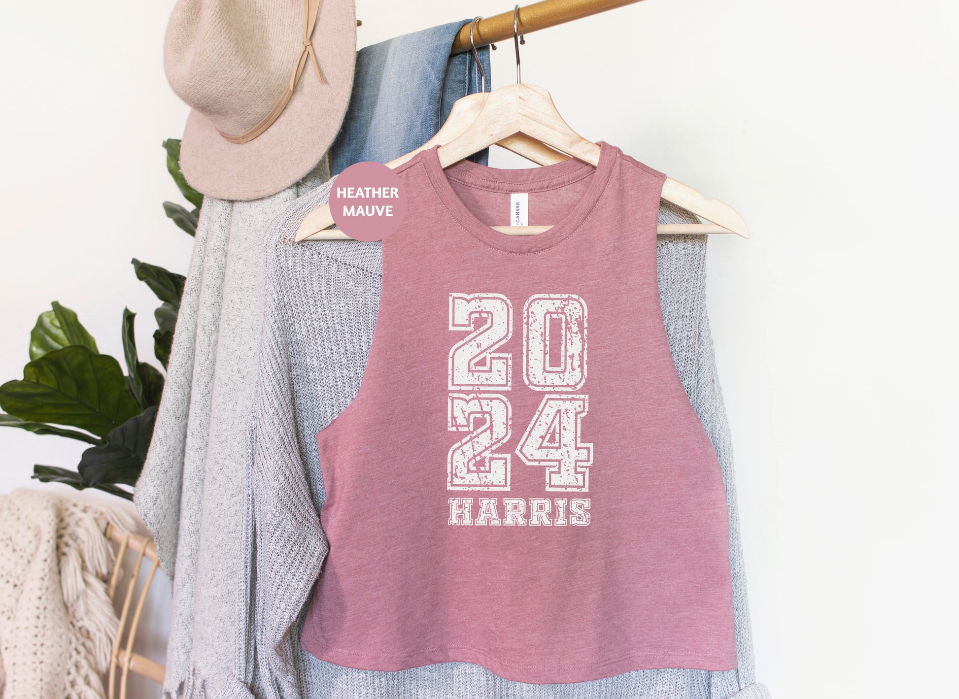 a pink shirt hanging on a rack next to a hat