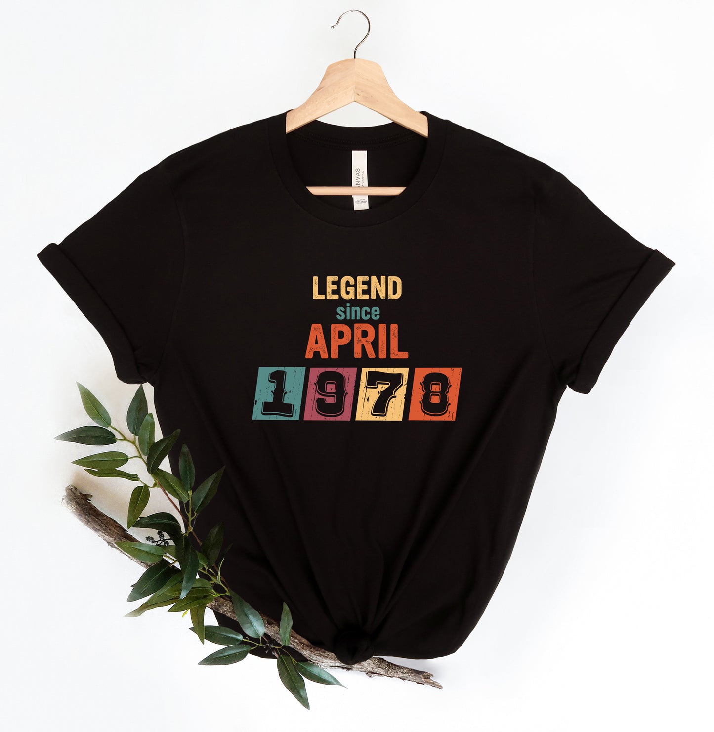 A black t-shirt with a colorful graphic design that says "LEGEND since APRIL 1978" printed on it.