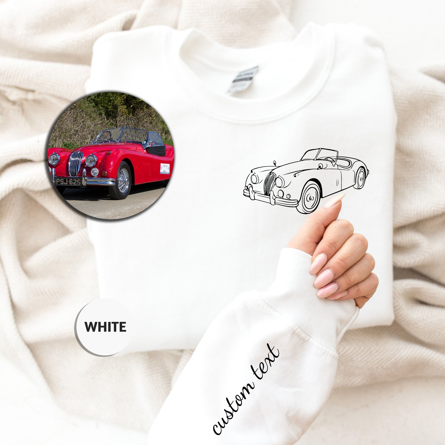 a person holding a white shirt with a red car on it