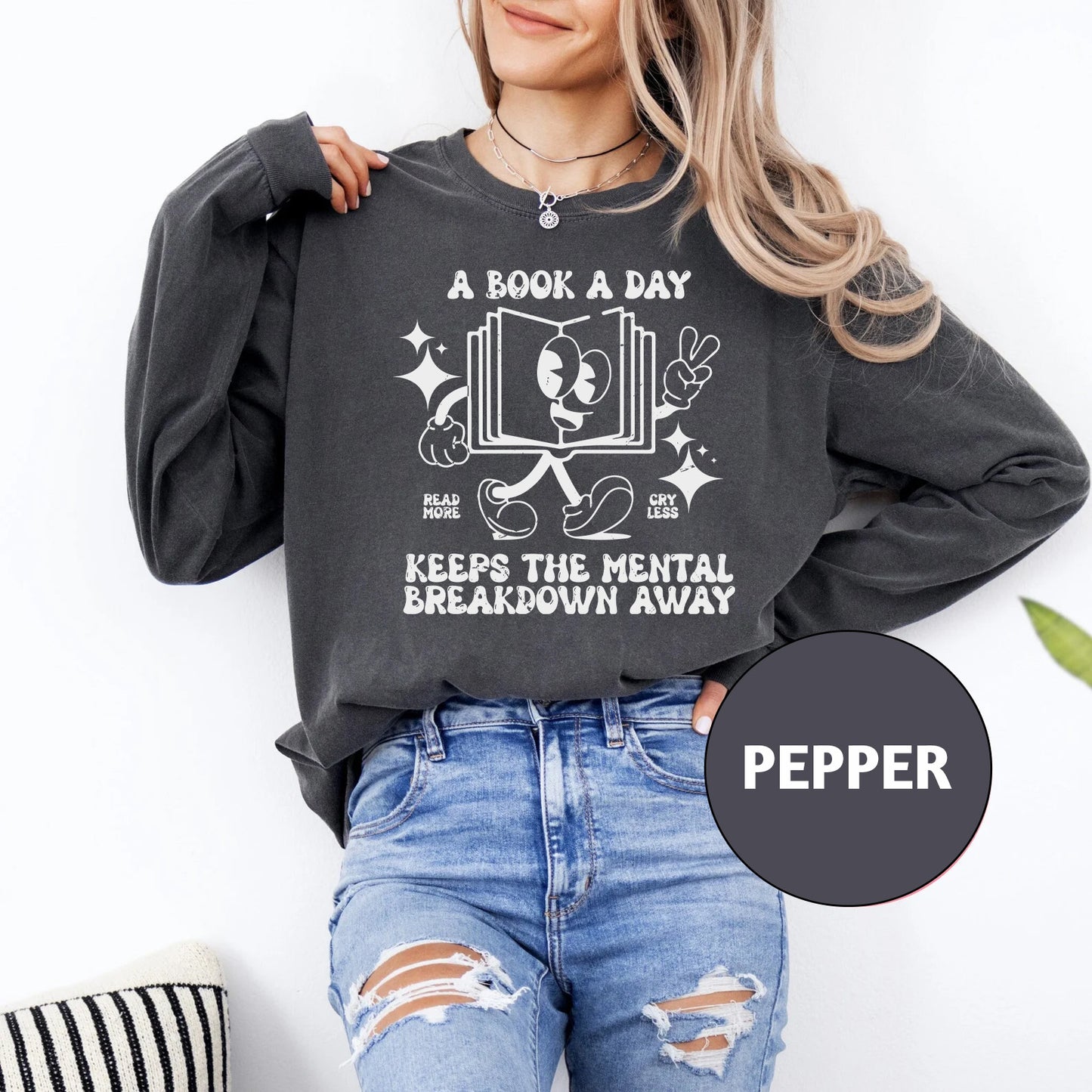 a woman wearing a book a day keeps the mental breakdown away sweatshirt