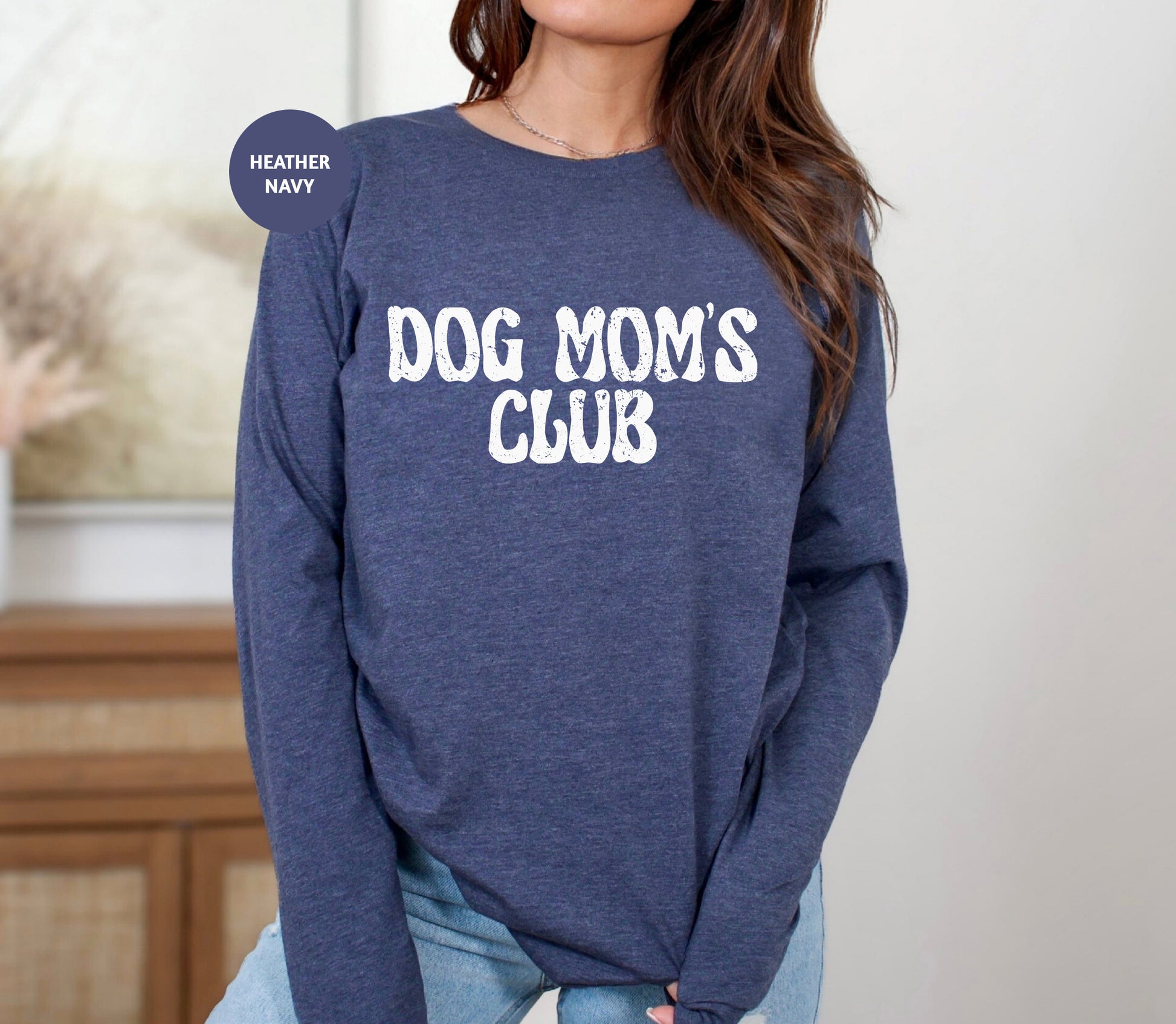 a woman wearing a dog mom's club sweatshirt