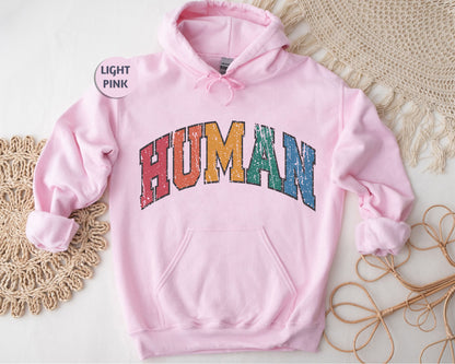 a pink hoodie with the word human printed on it