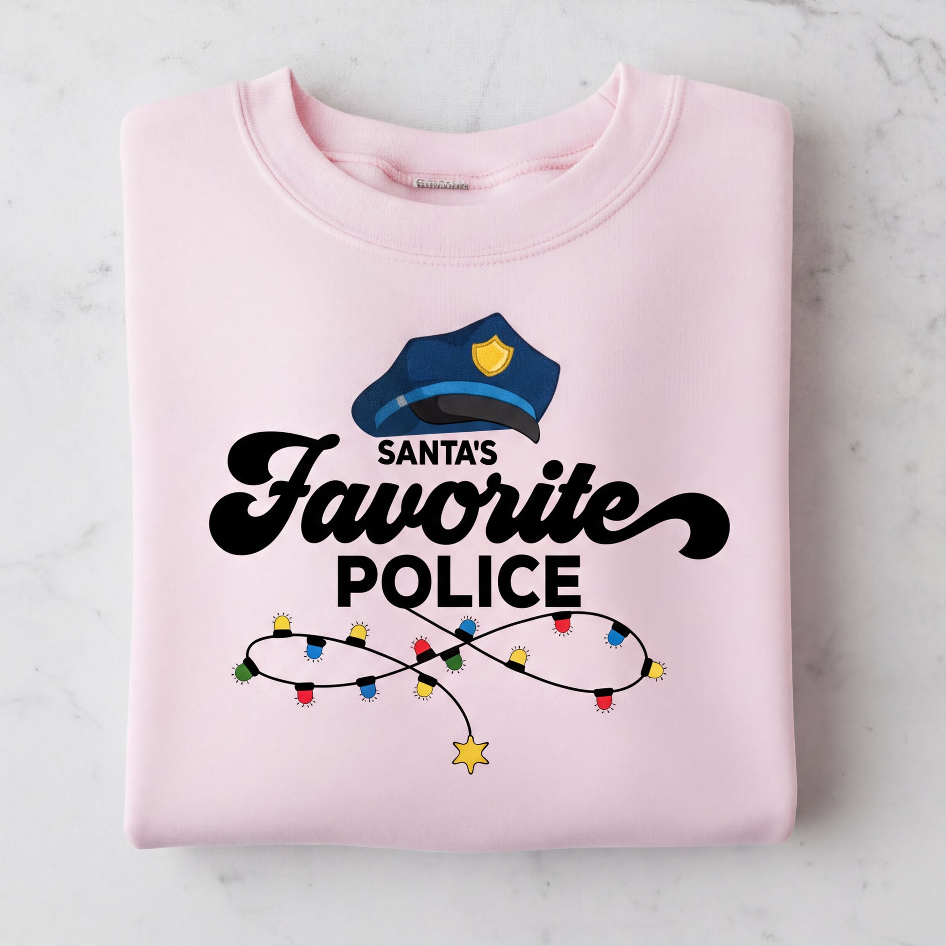 A pink sweatshirt with a graphic design featuring a police officer's hat and the text "Santa's Favorite Police" along with colorful lights.