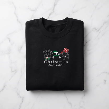 A black sweatshirt with a Christmas-themed design printed on it, featuring a panda, a reindeer, and a snowman.
