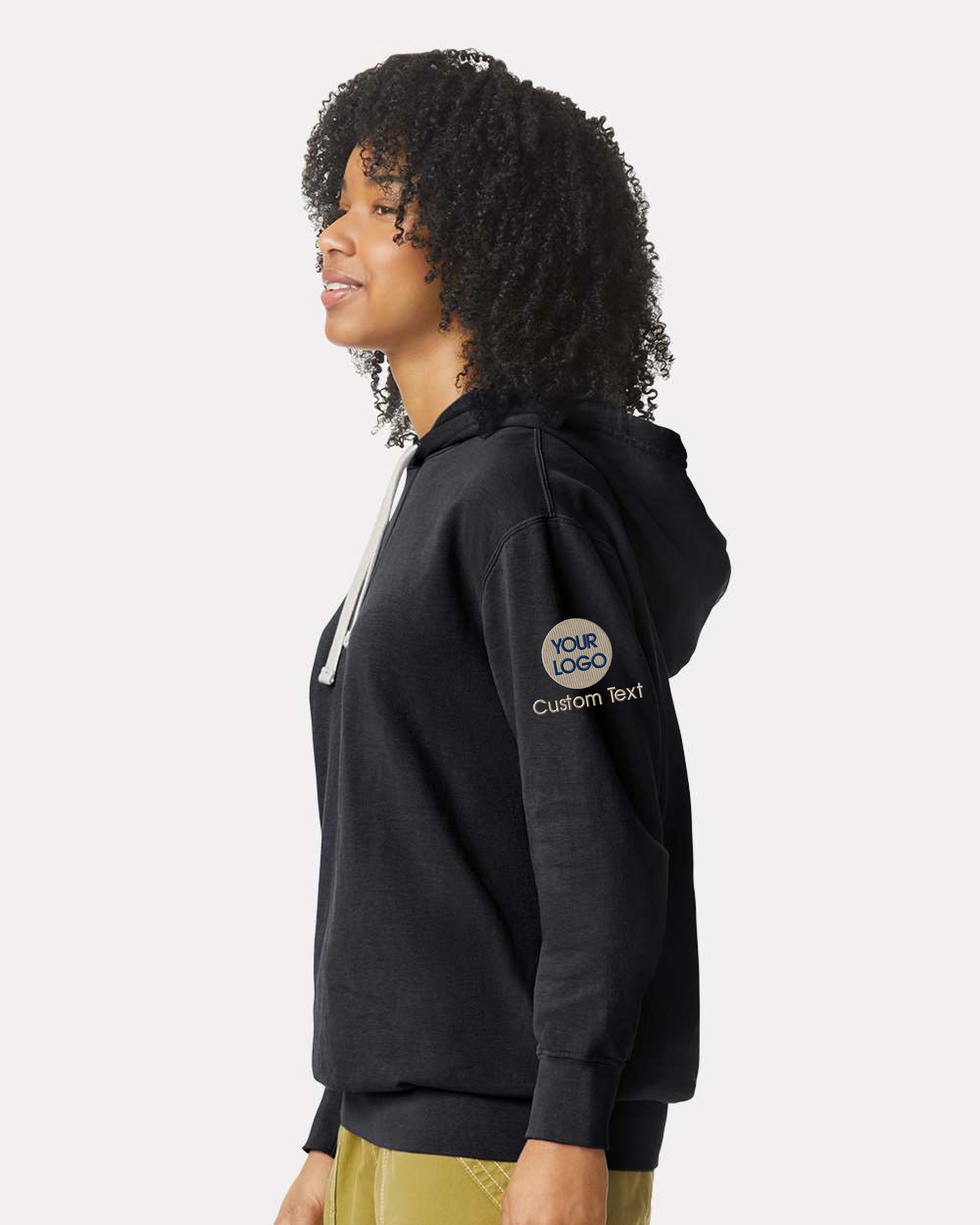 a woman wearing a black hoodie with a logo on it